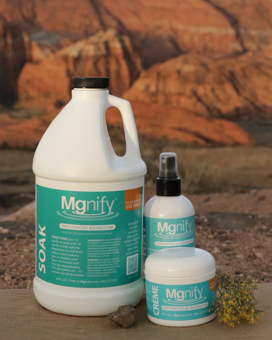 Mgnify 64oz soak, spray, and crème on a red-rock ledge at golden hour