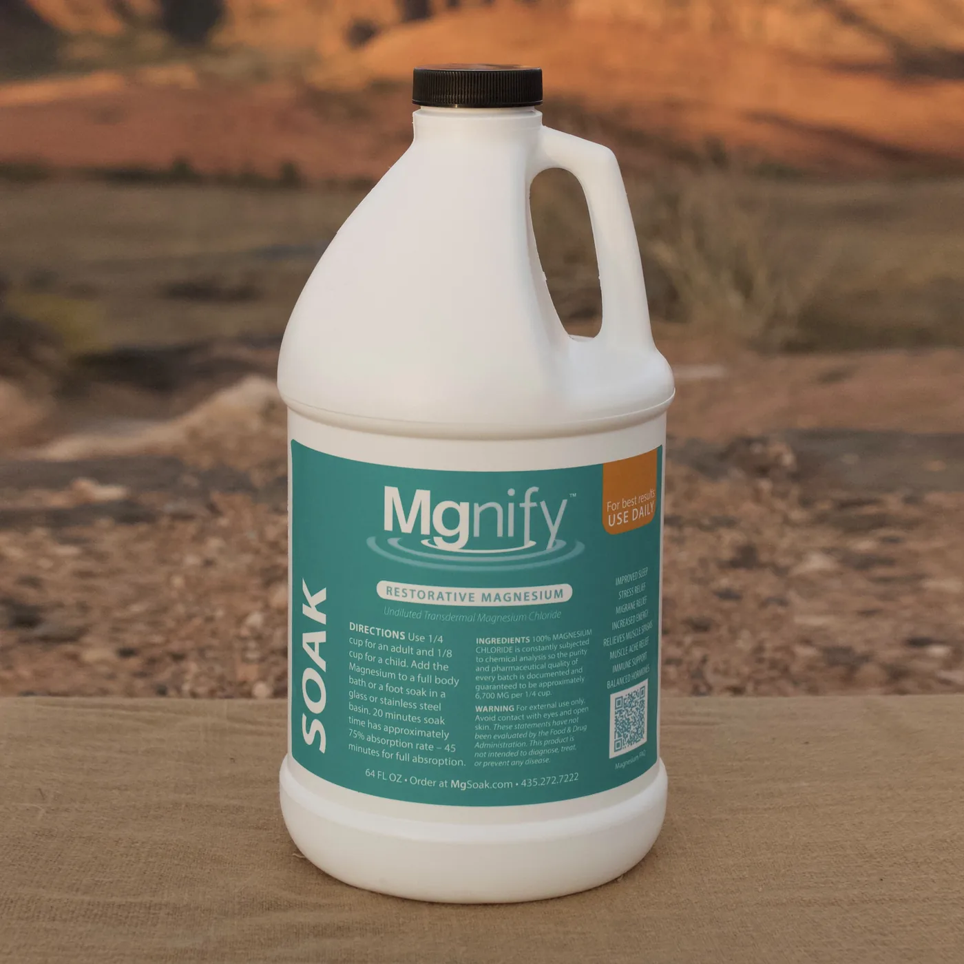 Mgnify Magnesium Chloride 64oz SOAK bottle on a red-rock ledge at golden hour